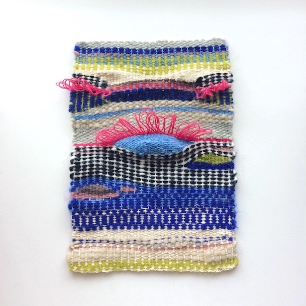 Rectangular weaving, resembling a sunrise over water. In blues, hot pink, chartreuse, purple, browns, black, white and beige.