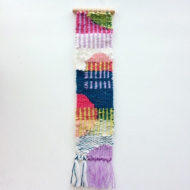 Narrow, rectangular weaving, featuring colorblocking, overlapping stripes and half circles. In teal, hot pink, lilac, chartreuse and white.