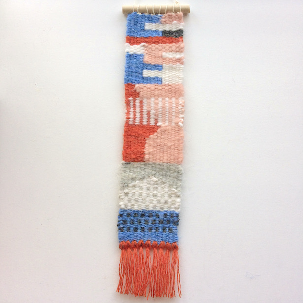 Narrow, rectangular weaving, featuring interlocking rectangles, stripes and dots. In blush, blue, orange, gray and white.