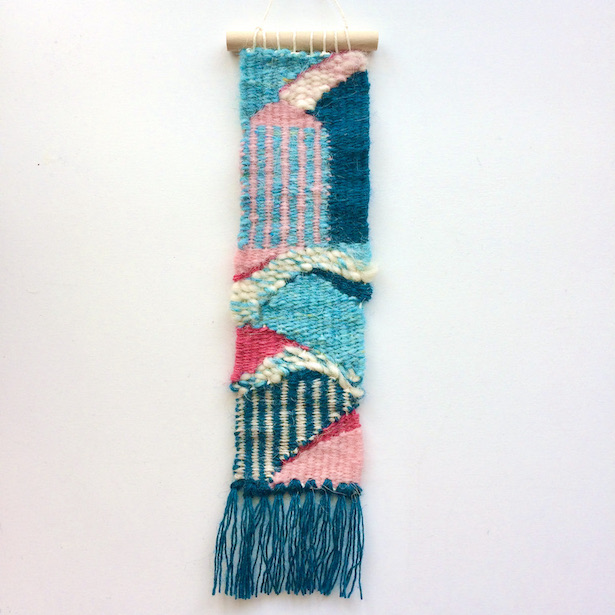 Narrow, rectangular weaving, inspired by rolling hills and old buildings. In aquas, teal, pinks and beige.