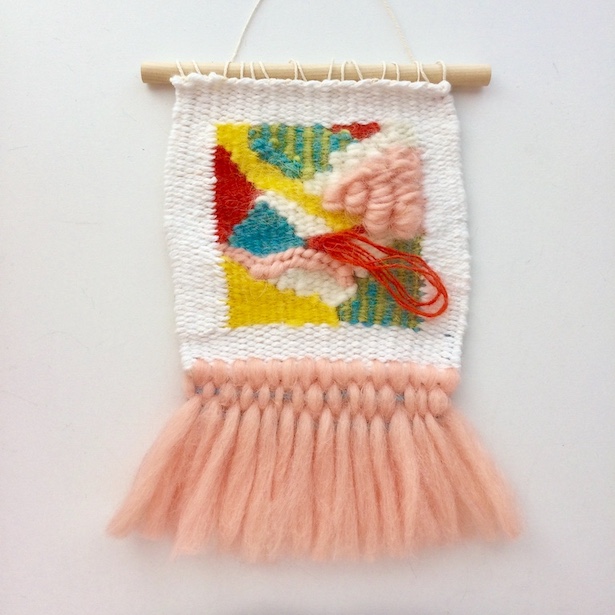 Square, abstract weaving, featuring rya loops and fringe resembling a tutu. In blush, yellow, orange, teal and white.