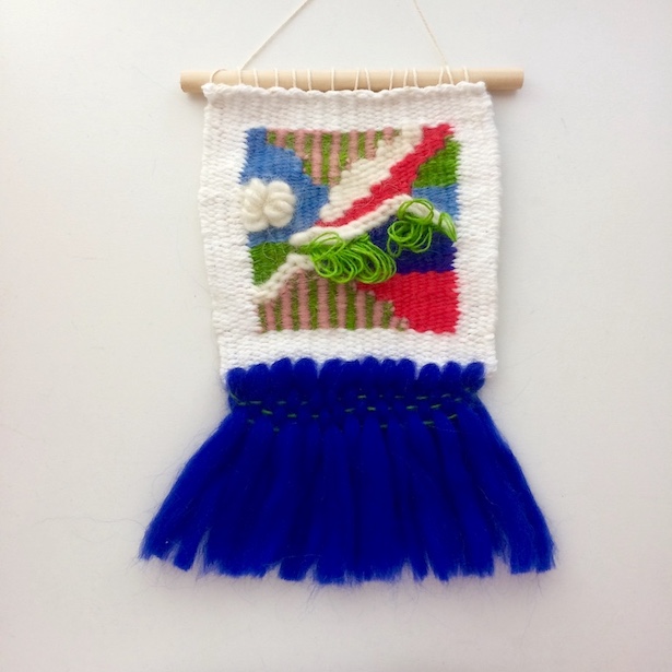 Square, abstract weaving, featuring rya loops and fringe resembling a tutu. In cobalt, red, green, blush, sky blue and white.