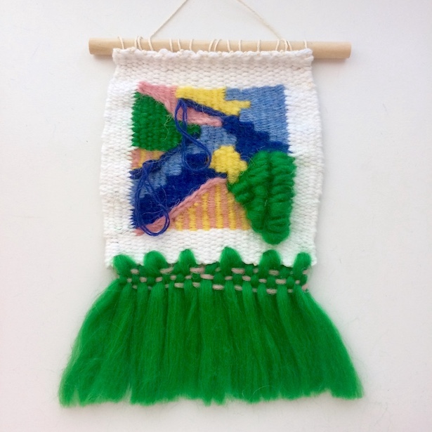 Square, abstract weaving, featuring rya loops and fringe resembling a tutu. In green, blues, yellow, blush and white.